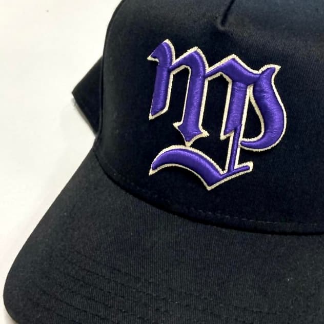 Embroidery machine close-up stitching detailed logo design