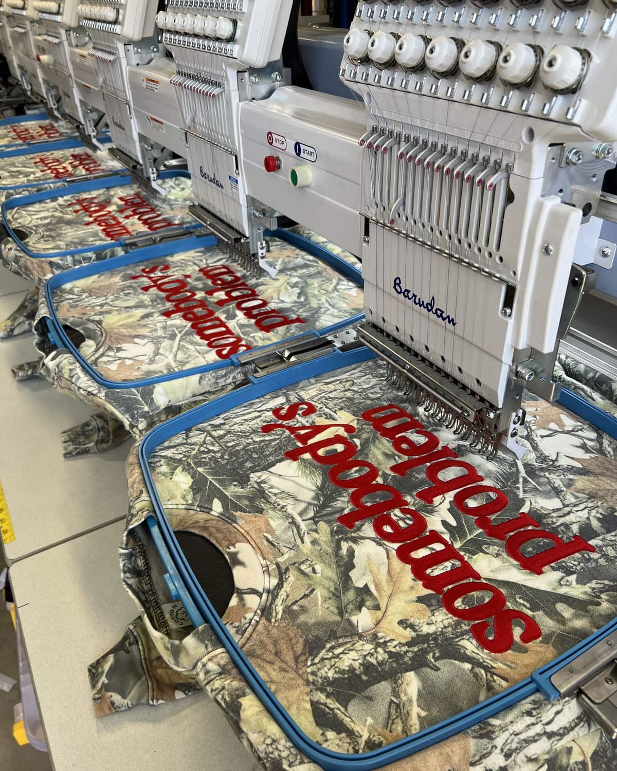 Multi-head embroidery machines running a bulk crewneck order at French Press Custom