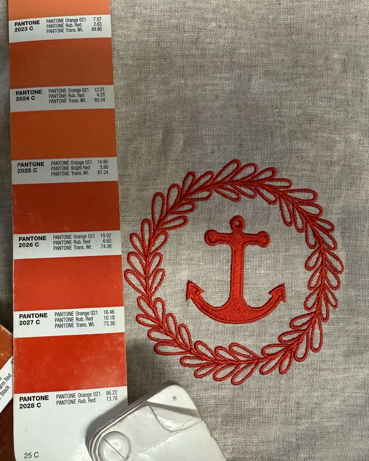 Thread colors matched against Pantone swatches for an embroidered stitch-out at French Press Custom